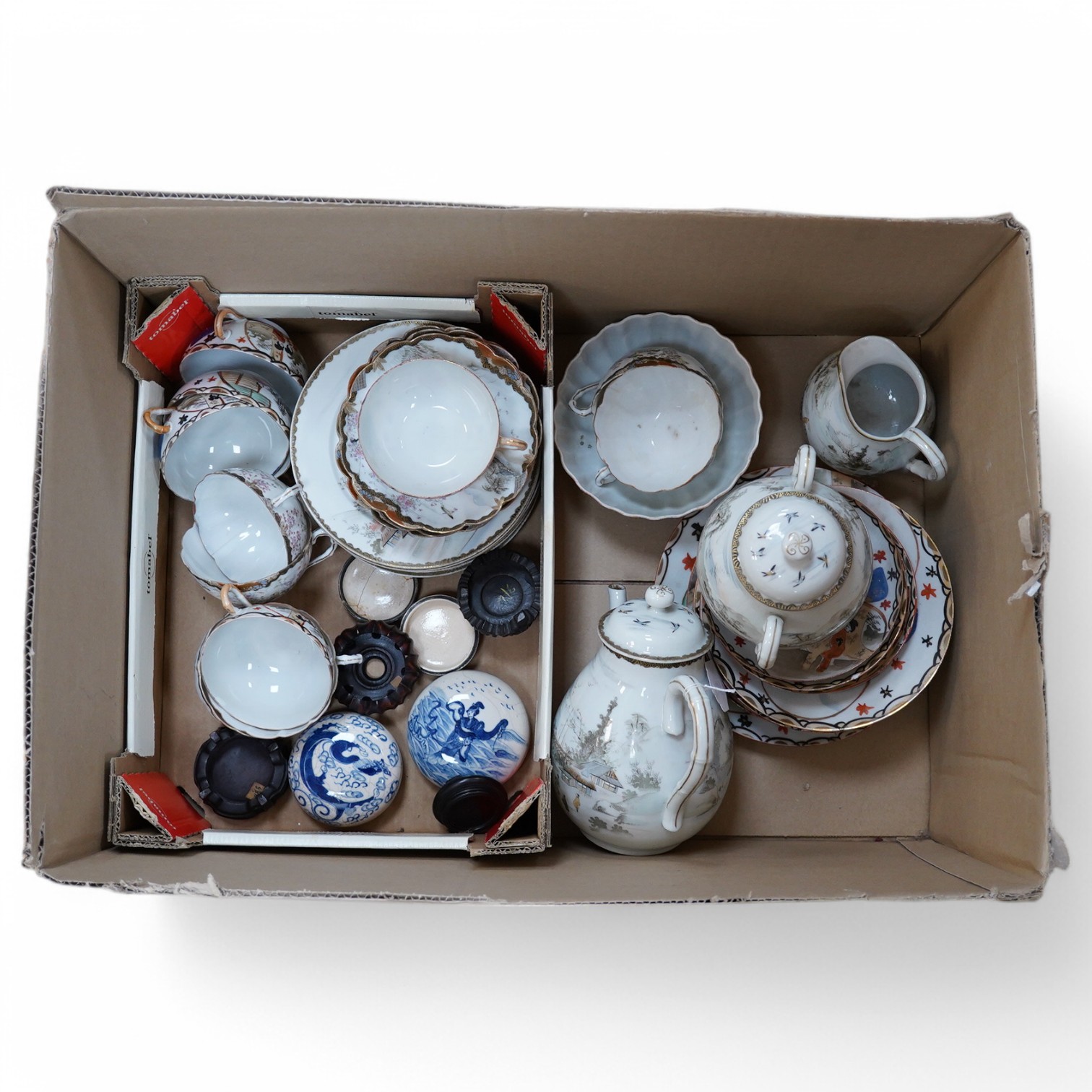 A Japanese eggshell tea and coffee set and three Chinese blue and white seal paste boxes and covers